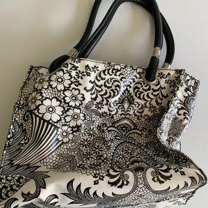 Oil cloth Flee Bag. Black and white exterior, pink interior waterproof.